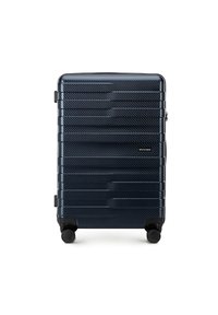 Valigia rigida di colore blu scuro con un design texturizzato e rigato. Dotata di quattro ruote nere e di una maniglia laterale per una facile manovrabilità.