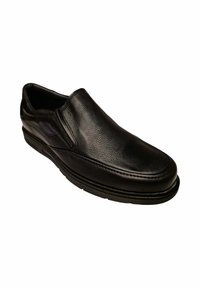 Zapato negro de piel sin cordones con un acabado suave, punta redondeada y costuras visibles. Suela acolchada para mayor comodidad.