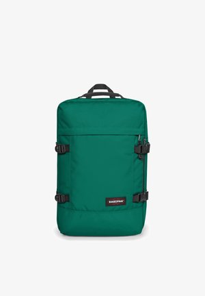 Grøn stofrygsæk med en rektangulær form, lynlåslomme foran, justerbare stropper og Eastpak-logo på den nederste forside.