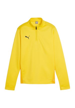Geel trainingsshirt met lange mouwen en een halflange ritssluiting, gemaakt van lichtgewicht stof. Heeft een zwart logo op de linker borst en gaasaccenten.