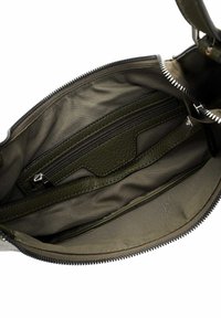 Interno di una borsa in pelle verde oliva, dotato di una tasca con zip, dettagli testurizzati e fodera in tessuto. Chiusura con zip sulla parte superiore.