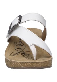 White leather sandal with two straps, a buckle accent, and a cork footbed featuring a plant pattern. Flat sole and open-toe design.