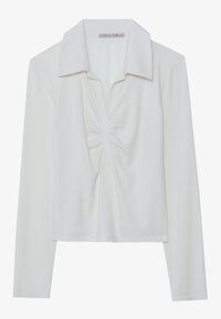 White long-sleeved top with a collar, featuring a center ruching detail and ribbed texture. Made from a soft, lightweight fabric.