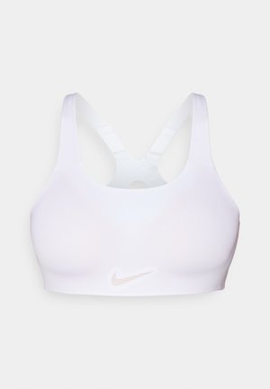 Reggiseno sportivo Nike bianco, caratterizzato da una texture liscia, design a racerback e un logo sottile di colore rosa chiaro al centro anteriore.