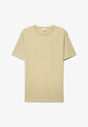 T-shirt beige clair à manches courtes et col rond avec un subtil motif hexagonal texturé, présenté à plat sur fond blanc.