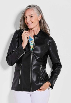 Black leather jacket with a stand collar, two zippered side pockets, and a sleek design. Smooth texture, fitted shape, and silver hardware accents.