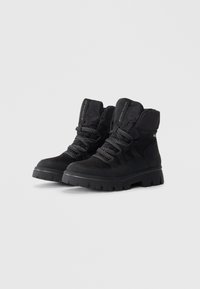 Black ankle boots with a suede and fabric upper, padded collar, and textured rubber sole. Features woven laces and a durable design.