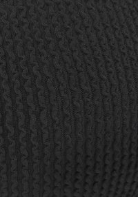 Black knitted fabric featuring a textured pattern with raised, wavy lines. The material appears soft and dense, suitable for various textile applications.