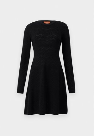 Black long-sleeve dress featuring a textured zigzag pattern, a round neckline, and an A-line silhouette. Soft knit material.