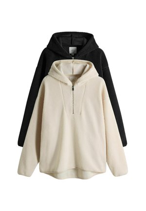Fleece-Hoodies in Schwarz und Creme, mit einem Viertel-Reißverschluss, weichem Material und großen Kapuzen. Beide haben einen lockeren, entspannten Schnitt.
