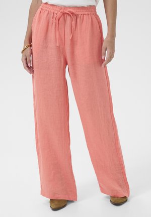Lightweight, coral linen pants with a relaxed fit. Features an elastic waistband with drawstring and wide legs. Smooth texture.