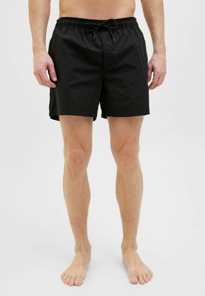 Schwarze Badehose mit einem elastischen Bund und verstellbarem Kordelzug. Sie verfügt über einen glatten, leichten Stoff und eine Länge bis zur Mitte des Oberschenkels.
