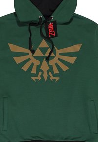 Zelená mikina s kapucí vyrobená z látky s hladkým povrchem. Na přední straně se nachází velký zlatý emblém TriForce a ptáka. Černé lemování.