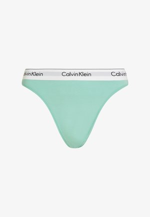 Mint green thong made of soft fabric, featuring a white waistband with black "Calvin Klein" branding. Smooth texture with minimal stitching.
