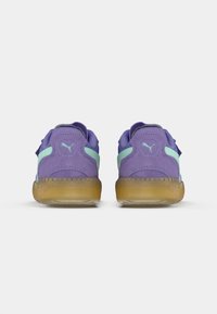 Sneakers viola con accenti azzurri, caratterizzati da una tomaia testurizzata e suola in gomma. Logo Puma visibile sul tallone.