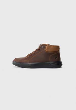 Brown leather high-top sneakers with a textured fabric upper, black rubber sole, and contrasting stitching. Lace-up closure with side logo detail.