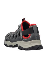 Gray outdoor shoe with red accents, mesh side panels, a padded collar, and a rugged sole. Features a stretchy loop and elastic laces.