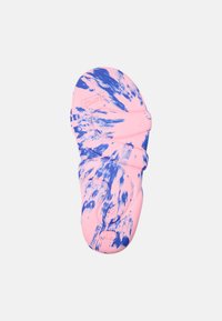 Footwear sole in pink with blue tie-dye pattern, made from flexible material; features rounded edges and textured surface for grip.