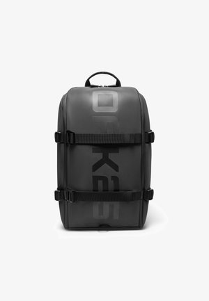 Schwarzer Rucksack mit matter Oberfläche, ausgestattet mit Seitenriemen, einem oberen Tragegriff und großem bedrucktem Logo. Rechteckige Form mit verstärkten Kanten.