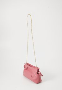 Pink leather shoulder bag with gathered sides and gold chain strap against a plain white background.