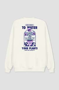 Felpa color crema con una grafica di una pianta in vaso e fiori in stile cartone animato. Il testo recita: "Non dimenticare di annaffiare le tue piante."