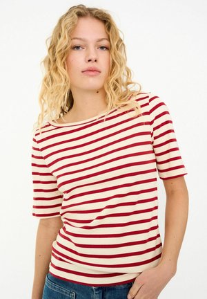 Striped t-shirt in cream with burgundy horizontal stripes, featuring short sleeves and a wide neckline, made from a soft, stretchy fabric.