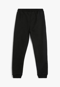Pantalones de chándal negros con cintura elástica y puños en los tobillos, mostrados planos sobre un fondo blanco.