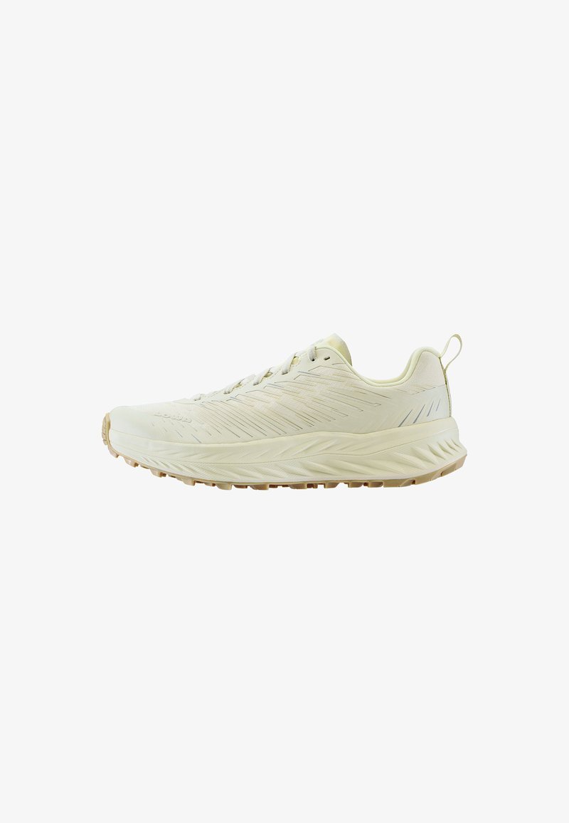 Light beige athletic shoe with textured upper, elongated shape, and a rubber sole. Features streamlined design and subtle pattern detailing.