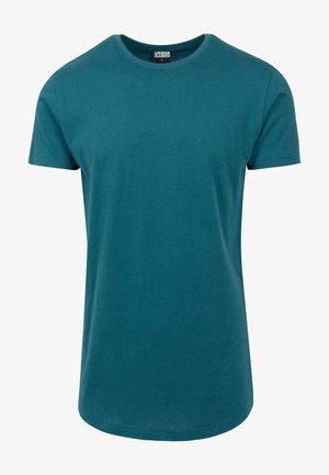 Mėlynas medvilninis marškinėliai su trumpomis rankovėmis, apvaliu kaklu ir tiesiu apvadu. Lygus paviršius, minimalus dizainas be raštų ar papuošimų.