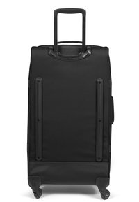 Maletín negro con una superficie de tela suave, mango retráctil, dos ruedas laterales y cuatro patas de apoyo en la base para mayor estabilidad.
