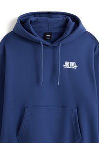 Navy blue Vans hoodie with front pocket, drawstring hood, and white "Vans World International" logo on the chest.