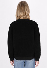 Schmuddelwedda Forro polar - schwarz