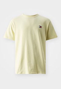 Yellow cotton t-shirt with short sleeves, round neckline, and a small, multicolored logo patch on the left chest area.