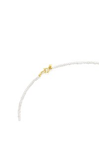Collana di perle delicata con piccole perle bianche rotonde e un luccicante fermaglio a molla dorato su uno sfondo bianco.