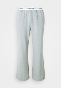 Graue, ausgestellte Sweatpants aus weichem Baumwoll-Mix, mit einem elastischen Bund und einem weißen Calvin Klein-Logo. Durchgehend glatte Textur.