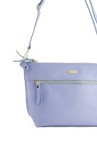 Lila Lederhandtasche mit strukturiertem Oberflächenmaterial, ausgestattet mit einem goldenen Reißverschluss und einem abnehmbaren Tragegurt. Verfügt über eine externe Reißverschlusstasche.