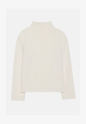Haut à manches longues de couleur crème avec un col montant, texture douce et coupe décontractée. Épaules sans couture et ourlet droit avec fentes sur les côtés.