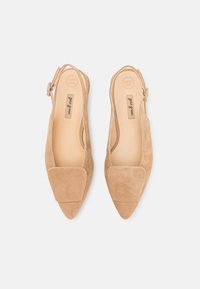 Beige suede pointed-toe slingback shoes with a wide, flat bow detail on the toe and an adjustable ankle strap. Smooth interior lining.
