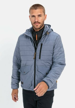 Blue quilted jacket with zippered front, attached hood, two front pockets, and contrast accents in a lightweight material. Lightweight and insulated.