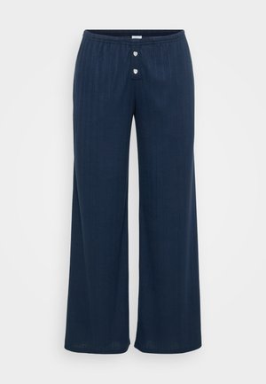 Granatowe spodnie o szerokich nogawkach z teksturowanym wzorem, z elastycznym paskiem w talii i dwoma okrągłymi srebrnymi guzikami z przodu.