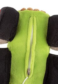 Green plush toy with black limbs showing a partially unzipped zipper along its back and small brown fabric bumps near top edge.