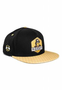 Cappello nero con visiera a motivo esagonale giallo. Presenta una grafica di orso e un patch con logo. Sul lato è presente un emblema di ape. Materiale in cotone.