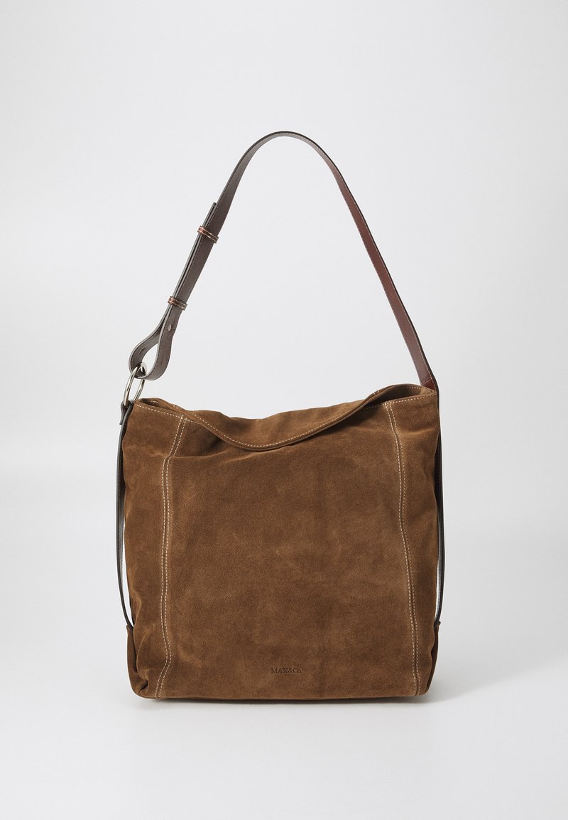 Brown suede handbag with a smooth texture, an adjustable leather strap, and contrasting white stitching details. Simple, slouchy design.