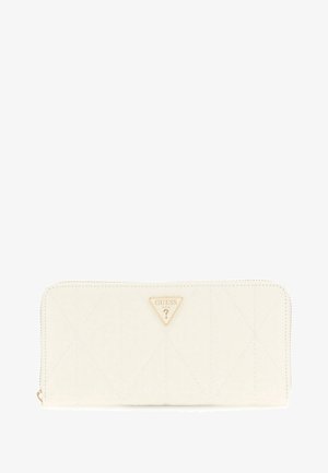 White quilted wallet made of synthetic material featuring a gold Guess logo triangle. Zipper closure and subtle stitching details enhance design.