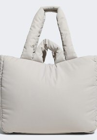 Light gray padded tote bag with two short handles, featuring a soft texture and a large, rectangular shape. No visible hardware or patterns.