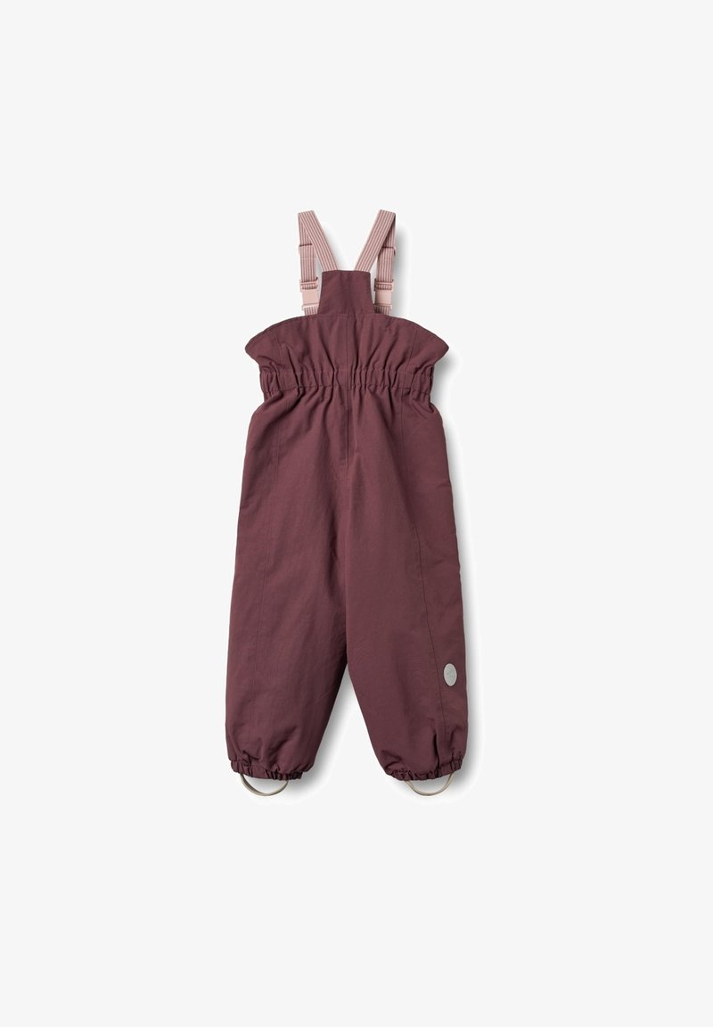 Bordeauxfarbene wasserdichte Latzhose mit elastischem Bund und verstellbaren Trägern. Verfügt über Metallösen am Saum und einem runden grauen Logo-Patch.
