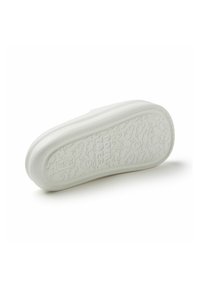 Suela de zapato de goma blanca con patrones texturizados que incluyen pájaros y corazones. Forma redondeada con bordes suaves y detalle elevado en los laterales.