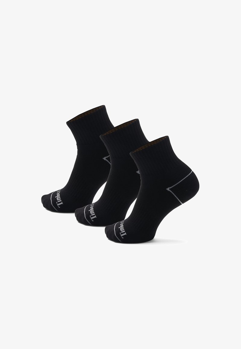 Calcetines negros con textura acanalada, de longitud media hasta la pantorrilla, con talón y puntera reforzados, que presentan un detalle de logo y un puño de color contrastante.