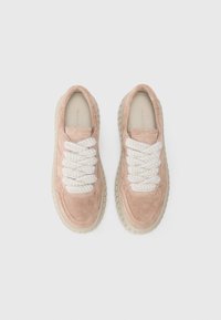 Light pink suede sneakers with chunky white laces and a textured rubber sole. Rounded design with a smooth inner lining.
