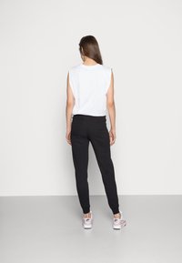 Nike Sportswear PANT TIGHT  - Jogginghose - black/white